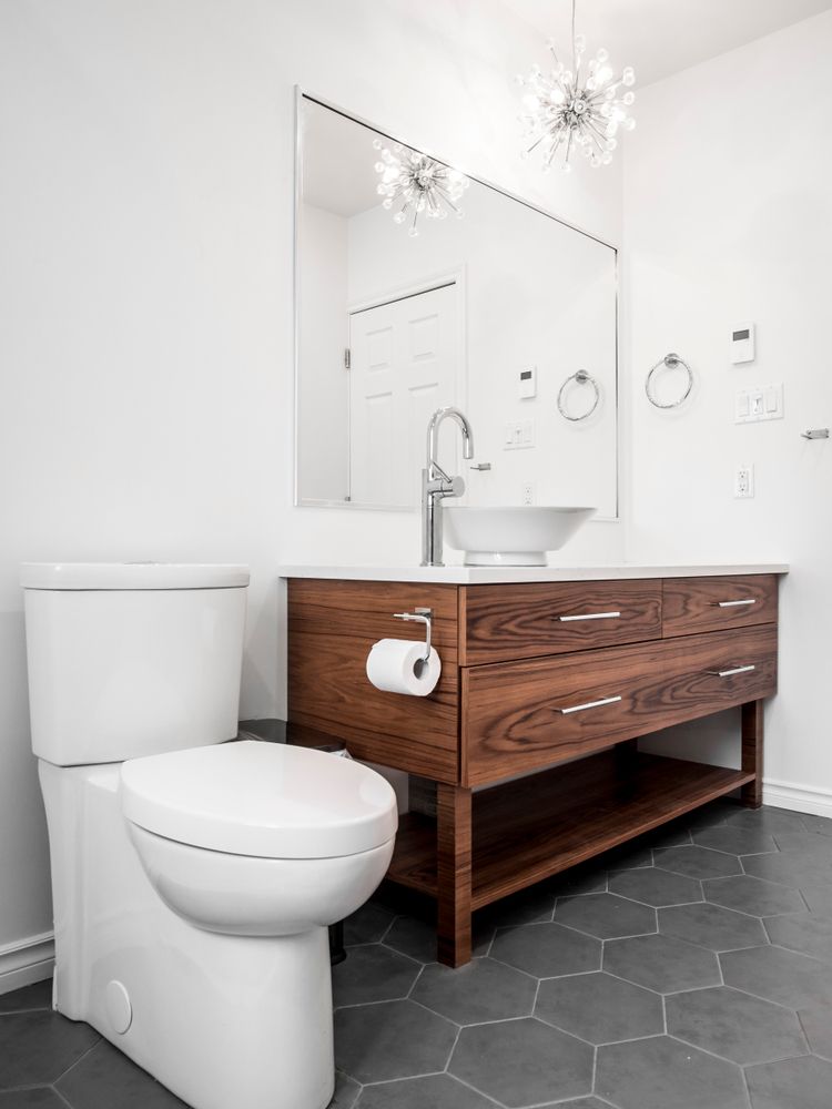 Modern Bathroom With White Toilet, Wooden Vanity — RWM Cleaning in Brendale, QLD