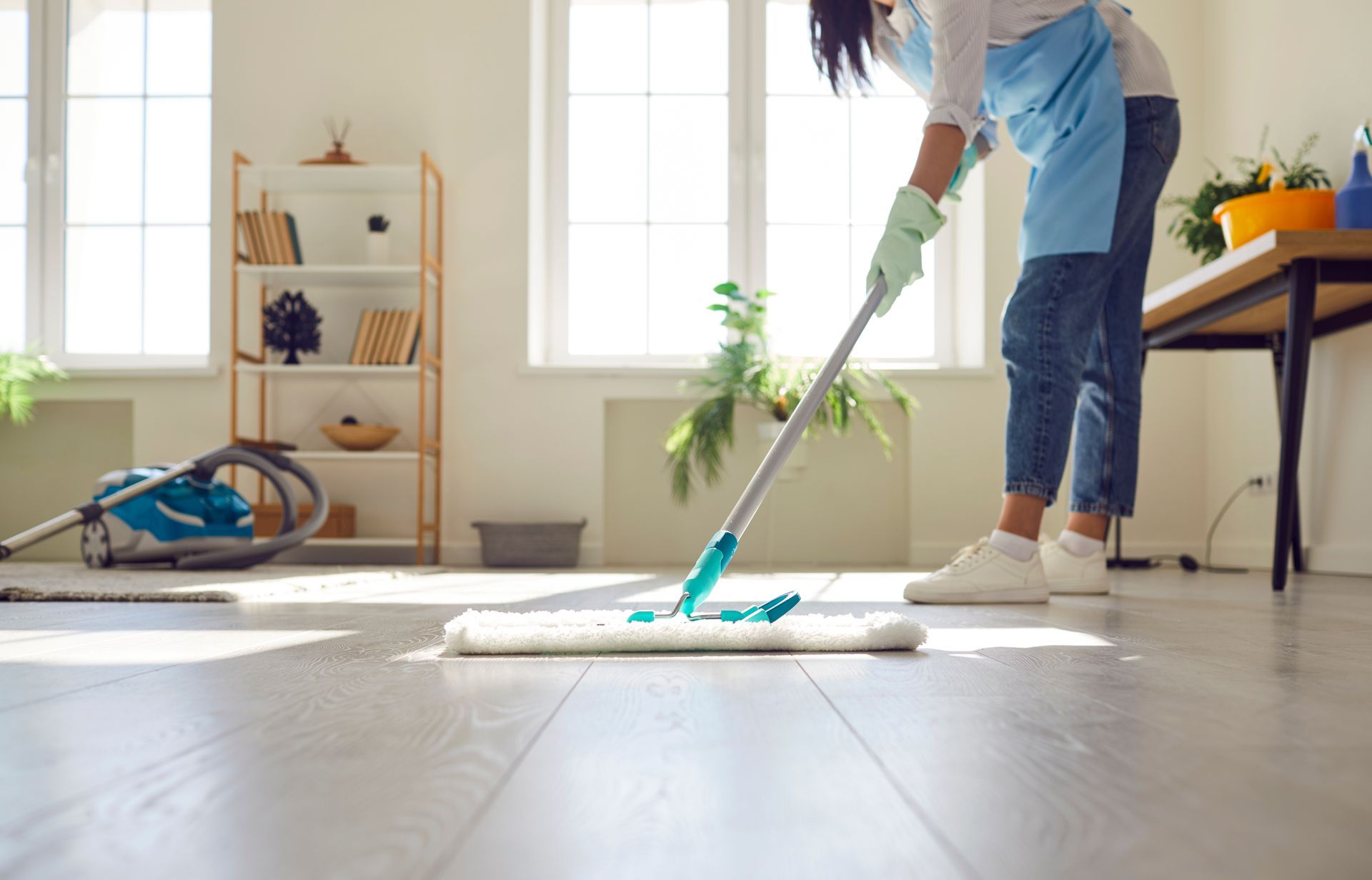 Person Mopping a Light-coloured Wooden Floor — RWM Cleaning in Deception Bay, QLD