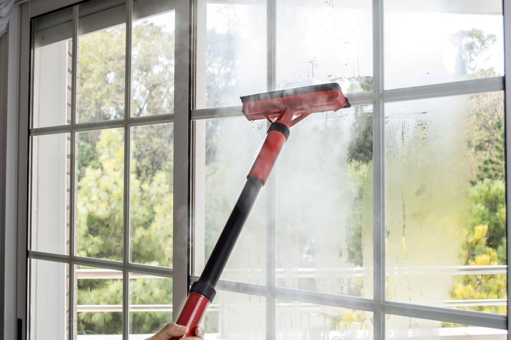 Person Cleaning a Foggy Window — RWM Cleaning in Deception Bay, QLD