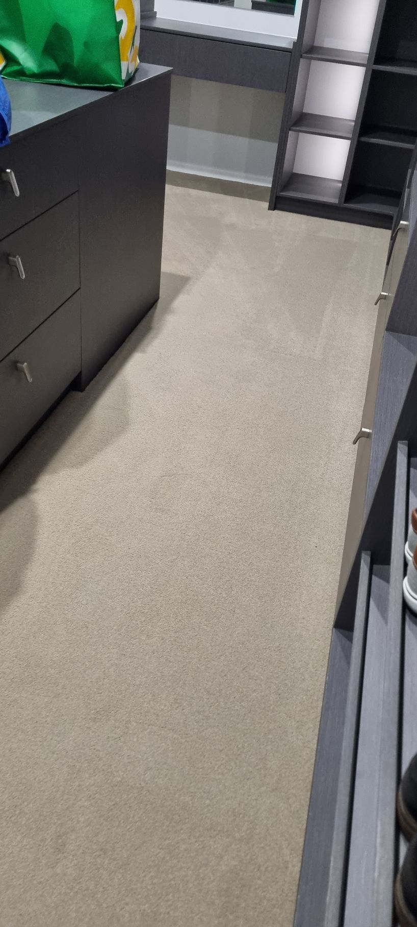A Beige Carpeted Room With Dark Gray Cabinets — RWM Cleaning in Deception Bay, QLD