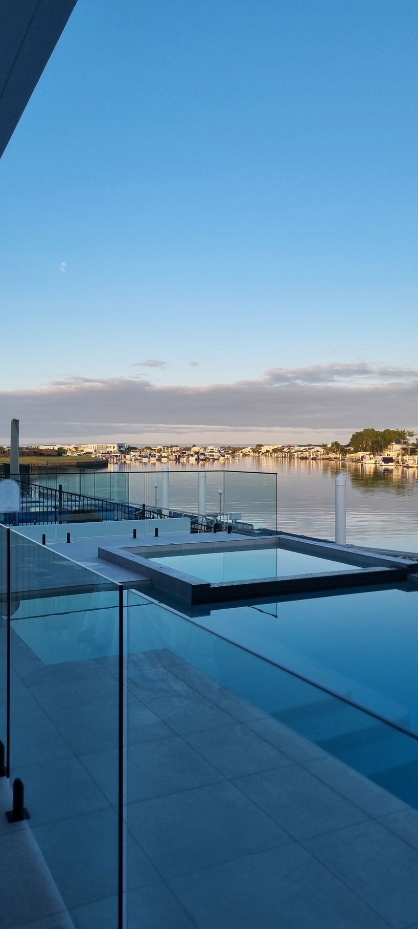 View of a Pool With Clear Glass Railings — RWM Cleaning in Deception Bay, QLD