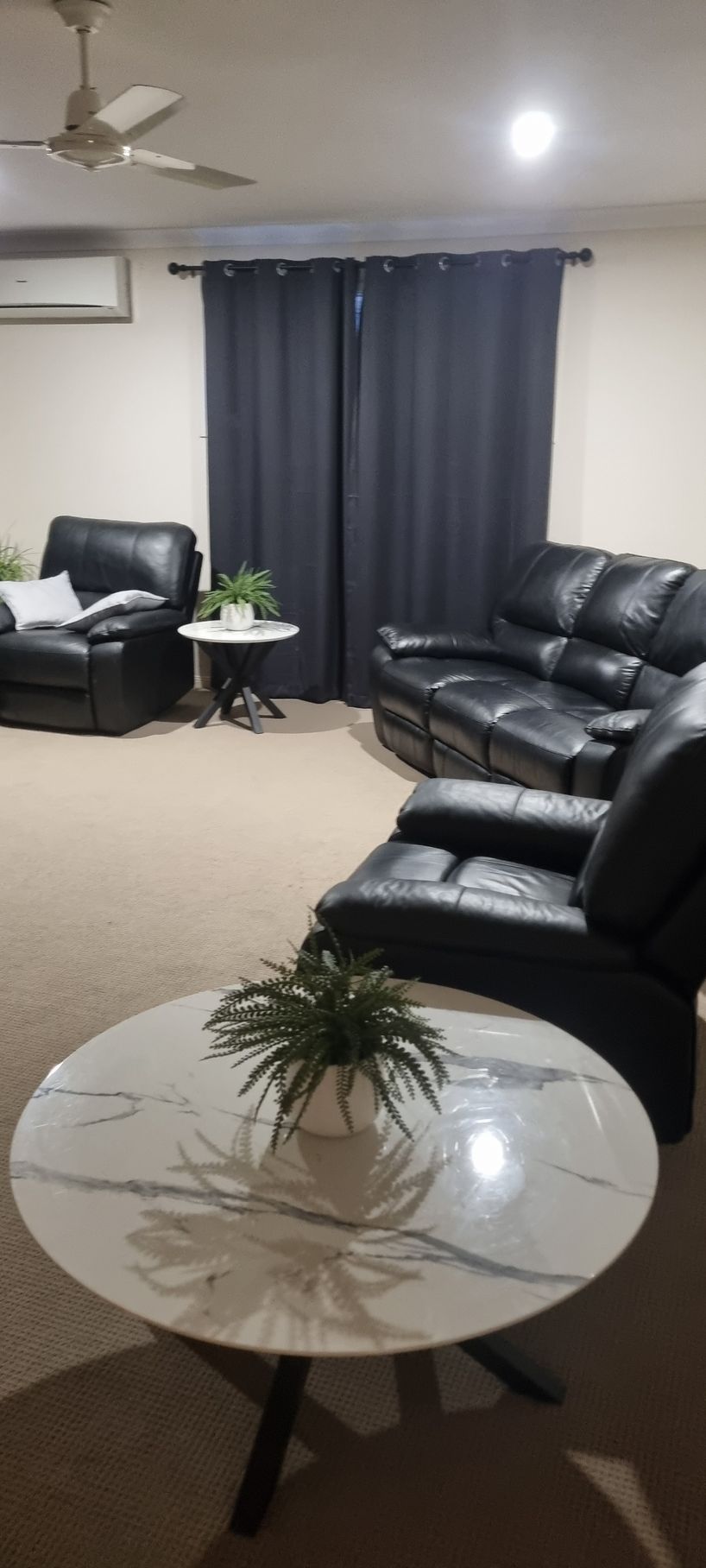 Living Room With Black Leather Furniture — RWM Cleaning in Deception Bay, QLD