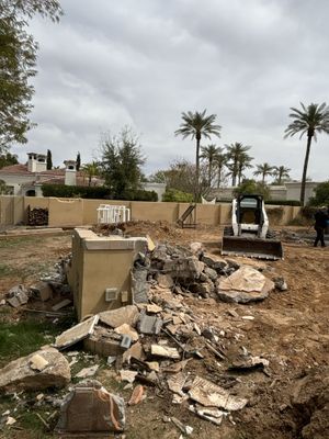 A bobcat is being used to dig a hole in the ground