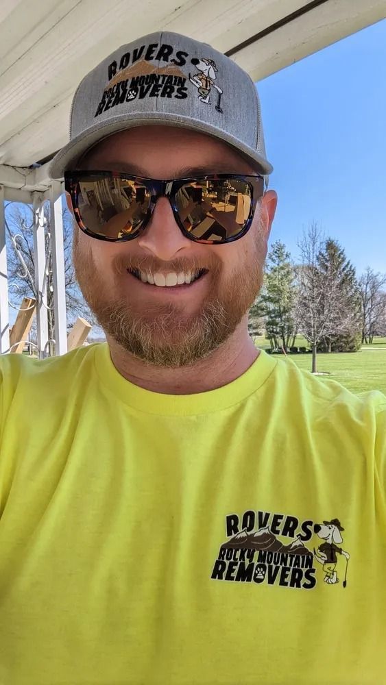 Man wearing sunglasses and a hat with 