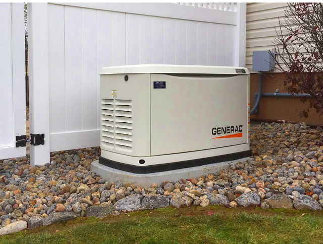 A generator is parked in front of a building under construction.