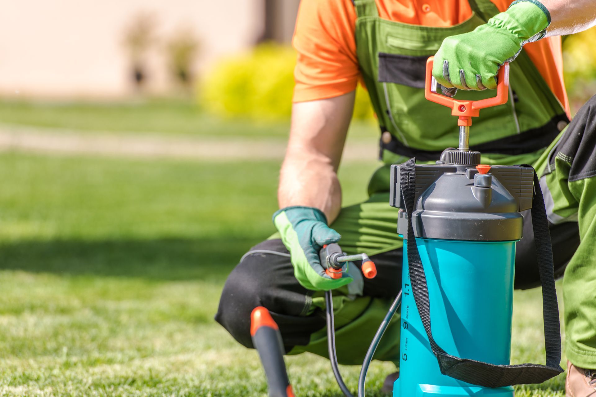 Lawn care technician preparing sprayer for commercial lawn treatment service