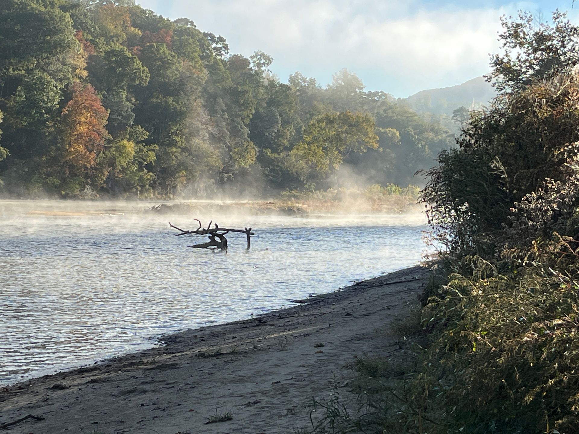A patio with a lot of furniture and lights at night.