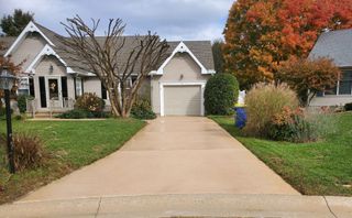 A driveway leading to a house with a garage