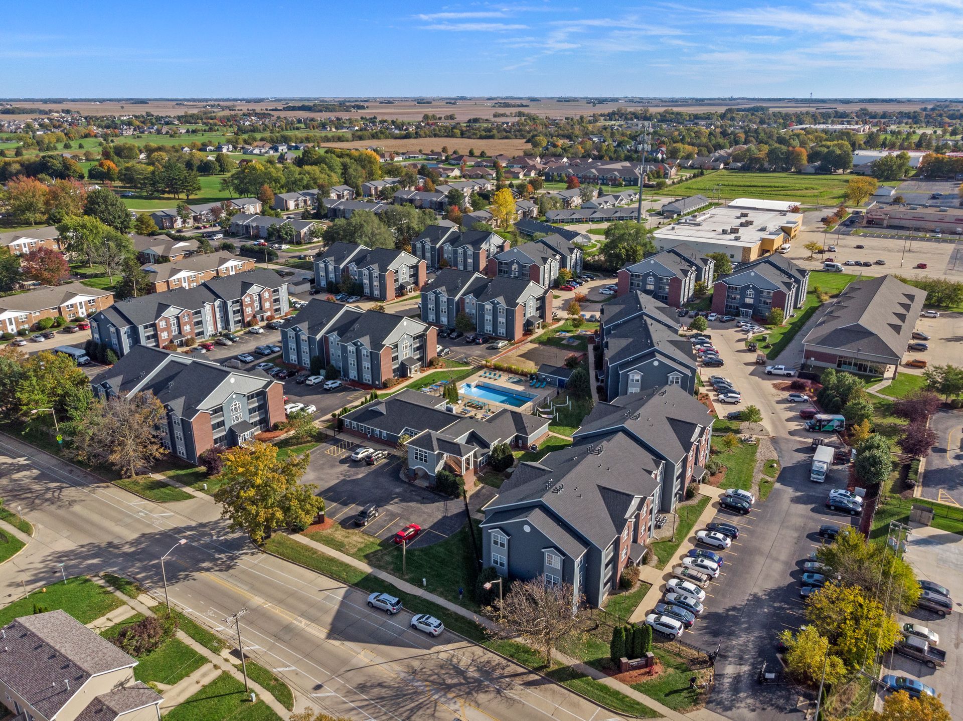 An aerial view of a residential area with lots of houses and a pool.