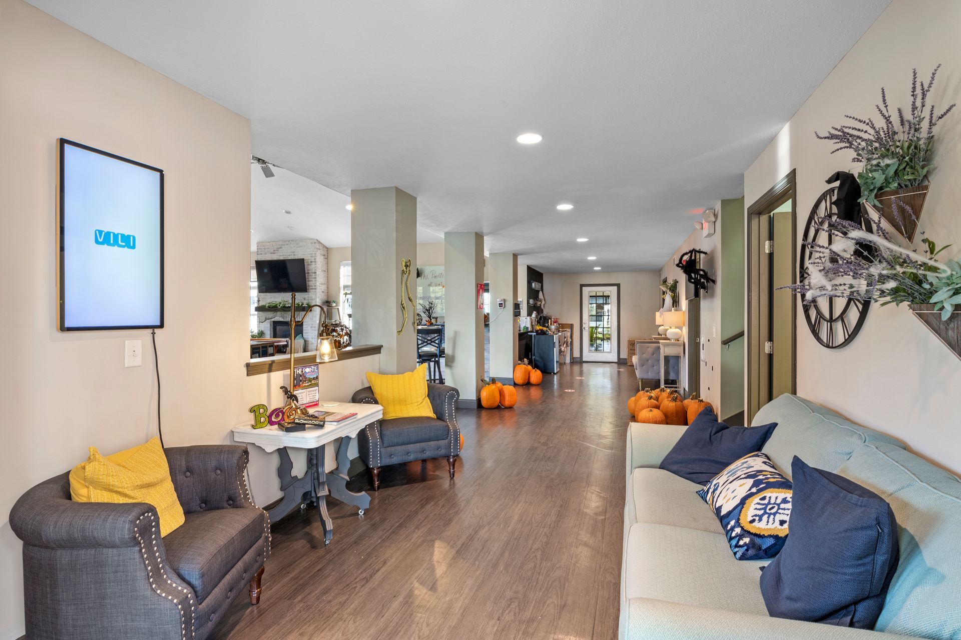 A living room with a couch , chair , table and television.