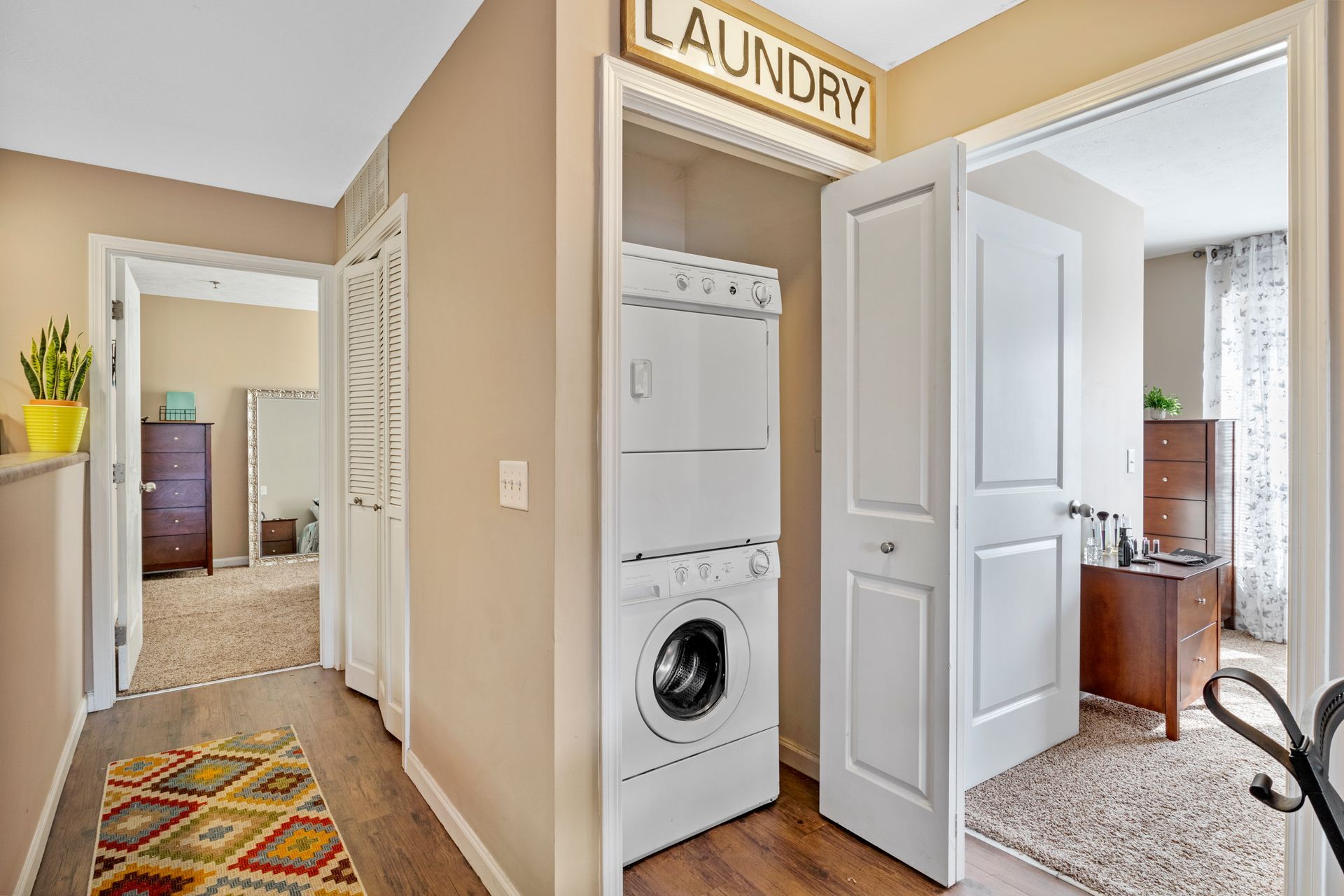 A laundry room with a washer and dryer stacked on top of each other.