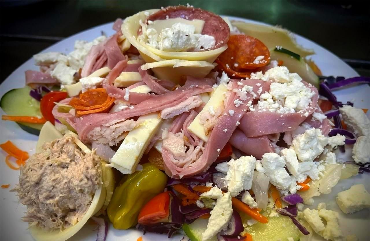 Close up of hand holding wine glass at table.