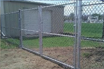 Chain link fence with a gate, outdoors.