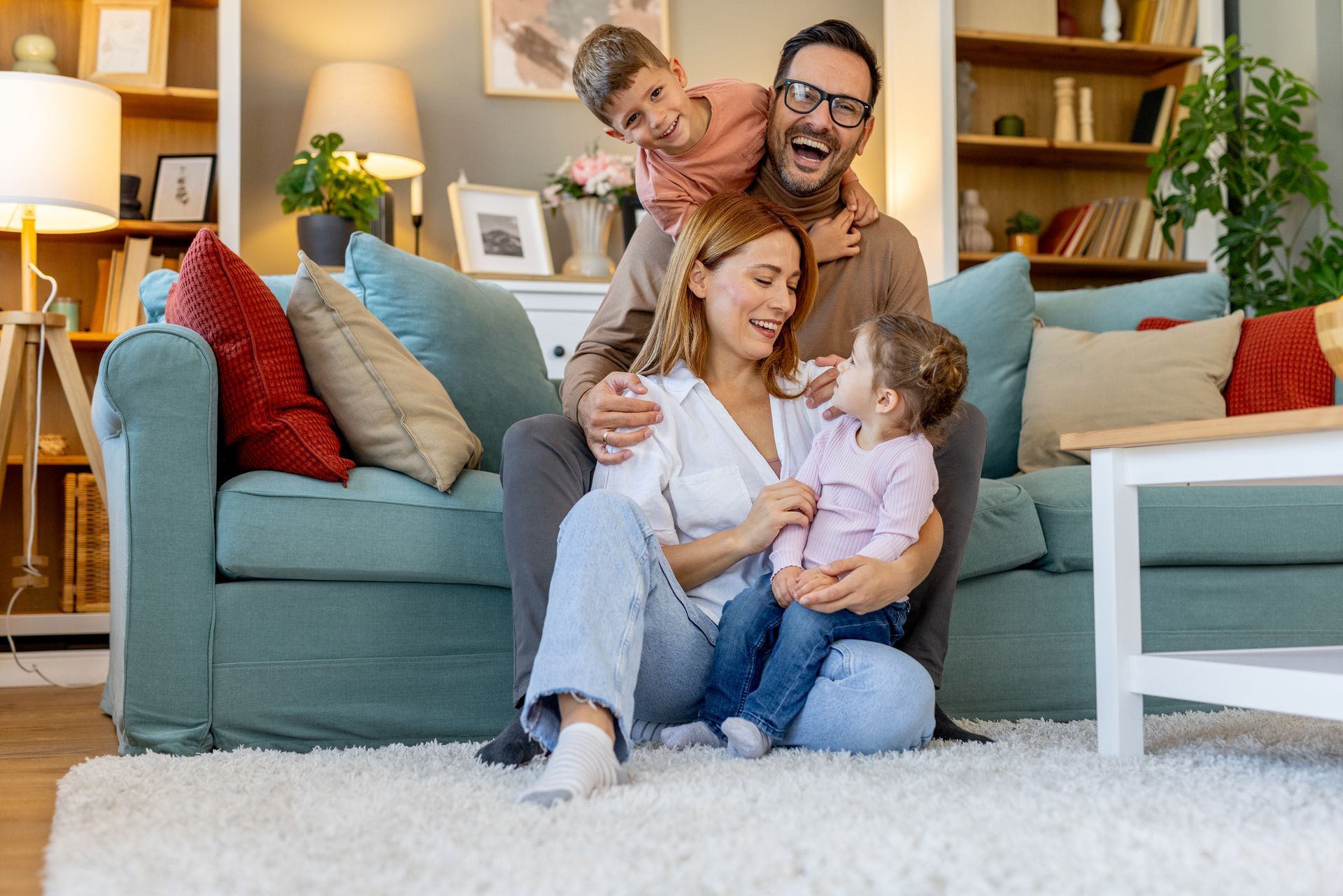 Person's finger pointing at the control panel of a white air purifier on a wooden floor. Person's finger pointing at the control panel of a white air purifier on a wooden floor.