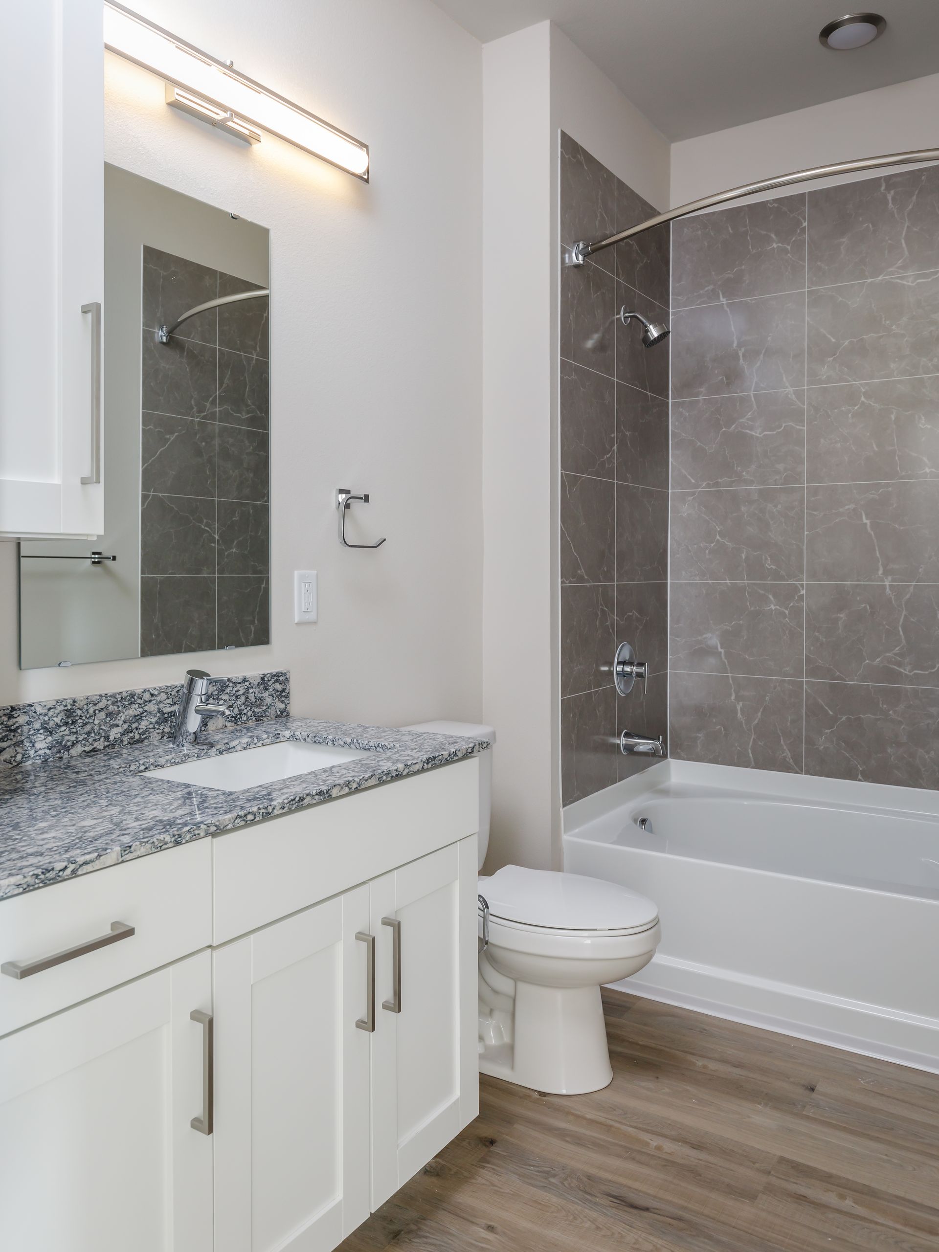 A bathroom with a toilet , sink and bathtub