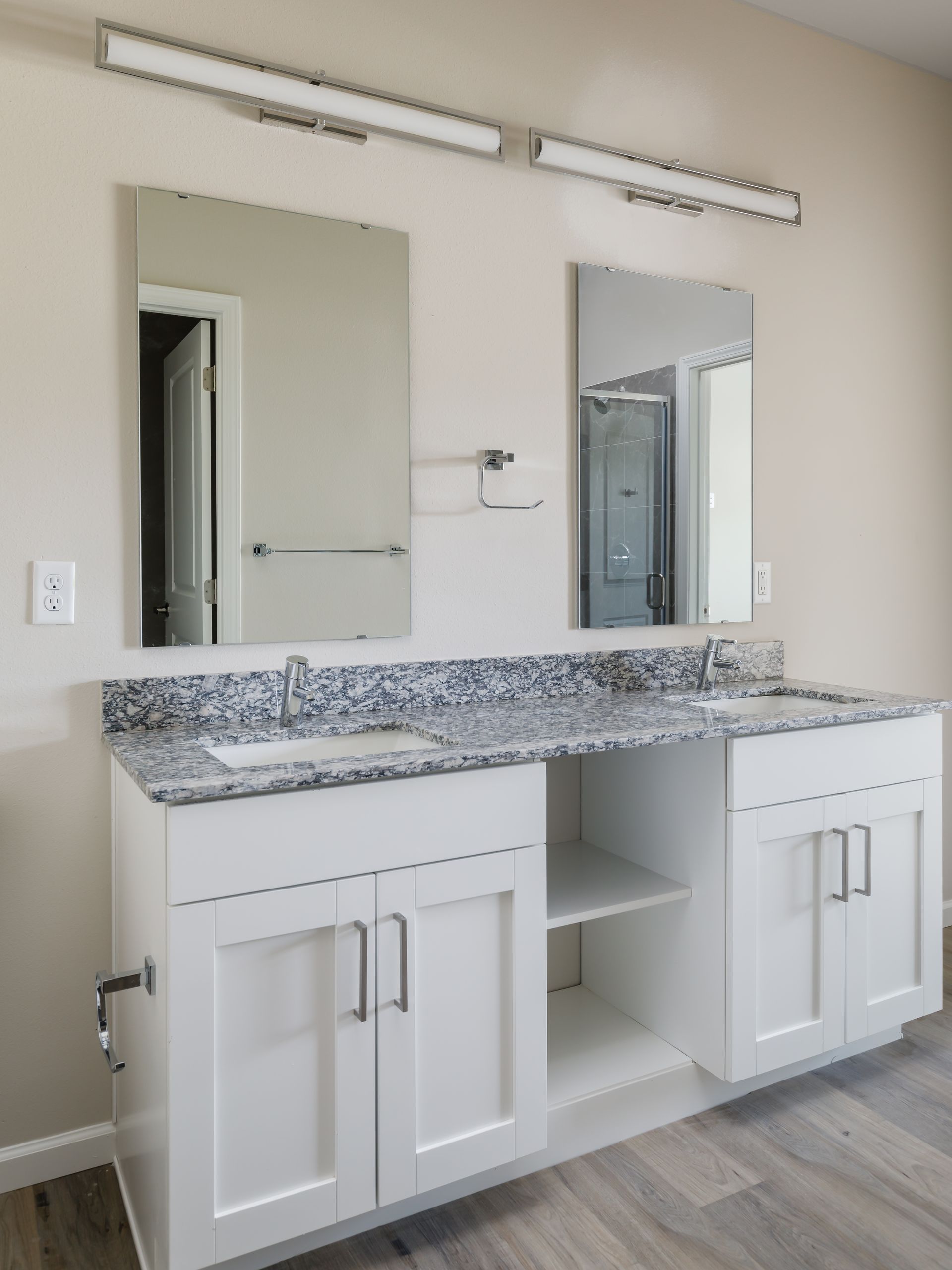 A bathroom with two sinks and two mirrors.
