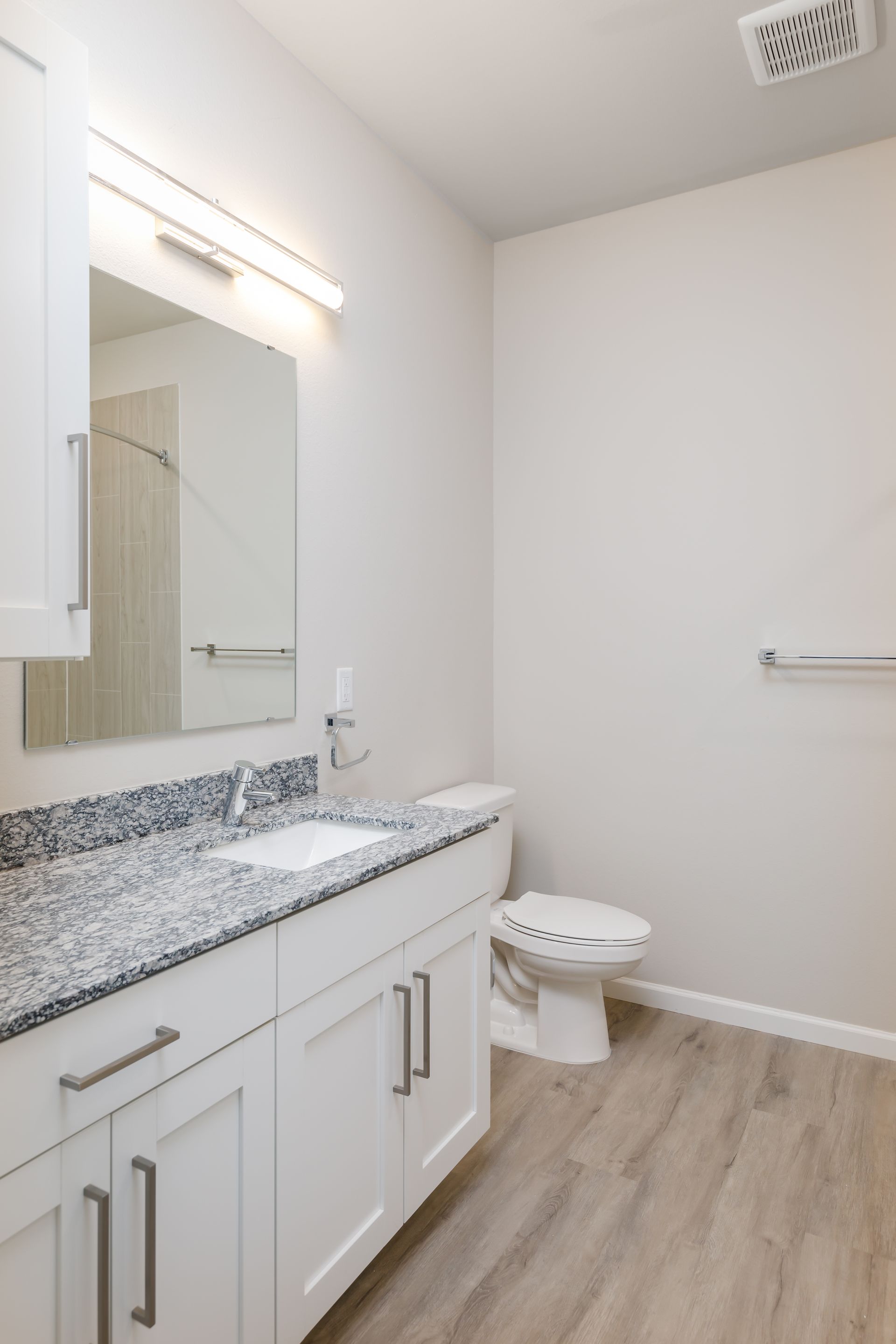 A bathroom with a sink , toilet and mirror