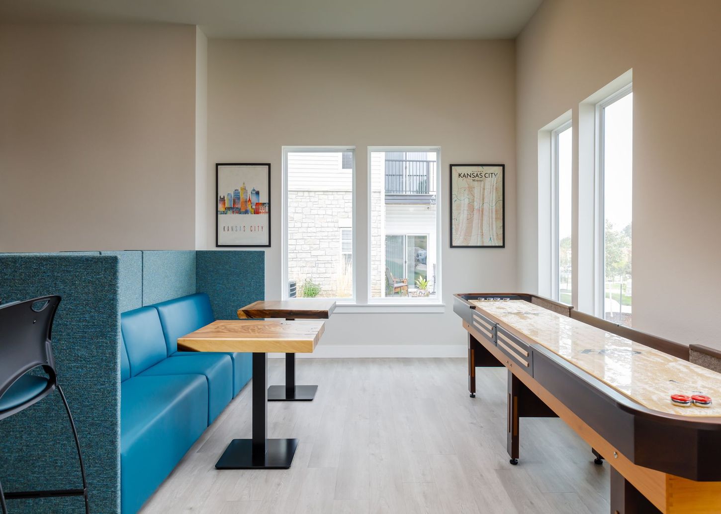 There is a shuffleboard table in the middle of the room.