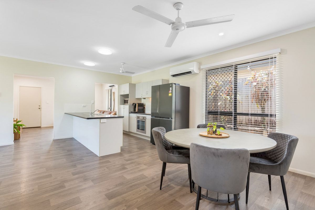 A Kitchen With A Table And Chairs And A Ceiling Fan — Cairns South Properties In Edmonton, QLD