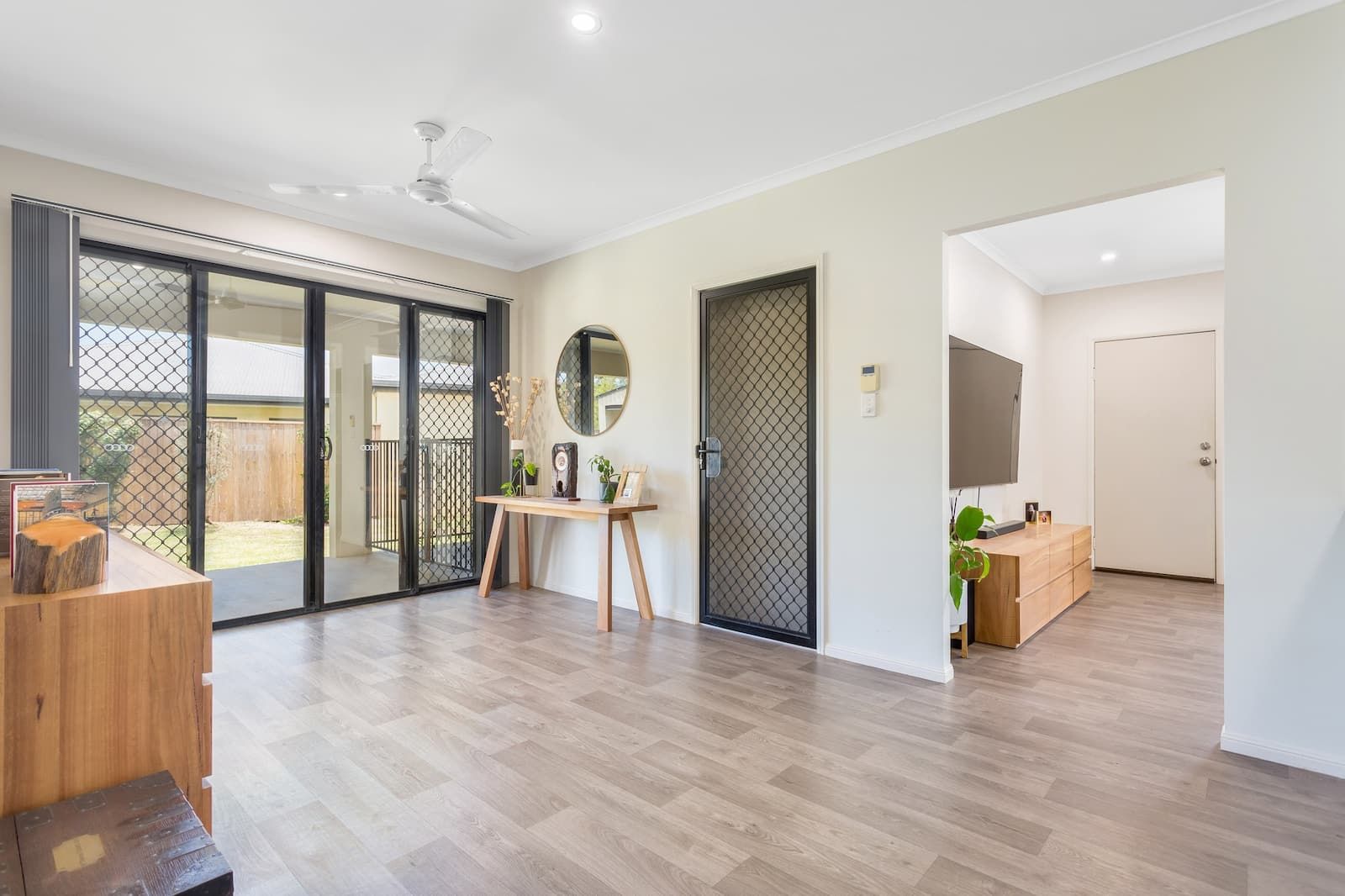 A Living Room With Hardwood Floors And A Ceiling Fan — Cairns South Properties In Bentley Park, QLD