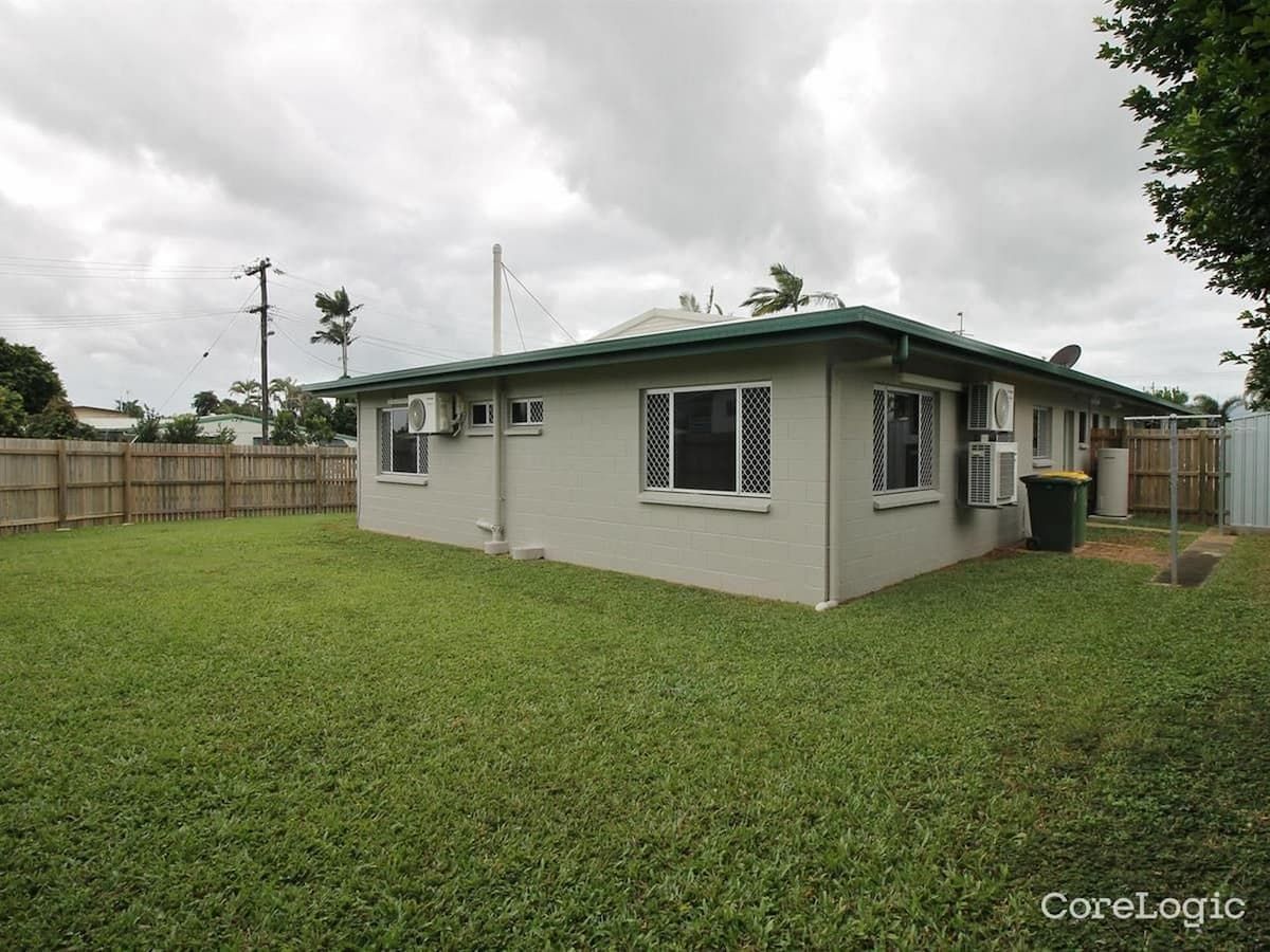 A Small White House With A Green Roof And A Large Lawn In Front Of It — Cairns South Properties In Edmonton, QLD