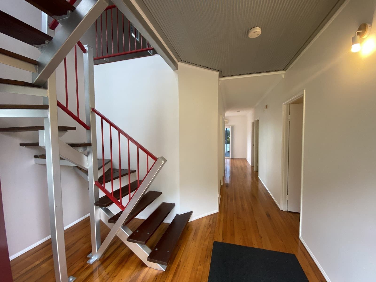 An Empty Hallway With A Spiral Staircase In The Middle — Cairns South Properties In Cairns, QLD
