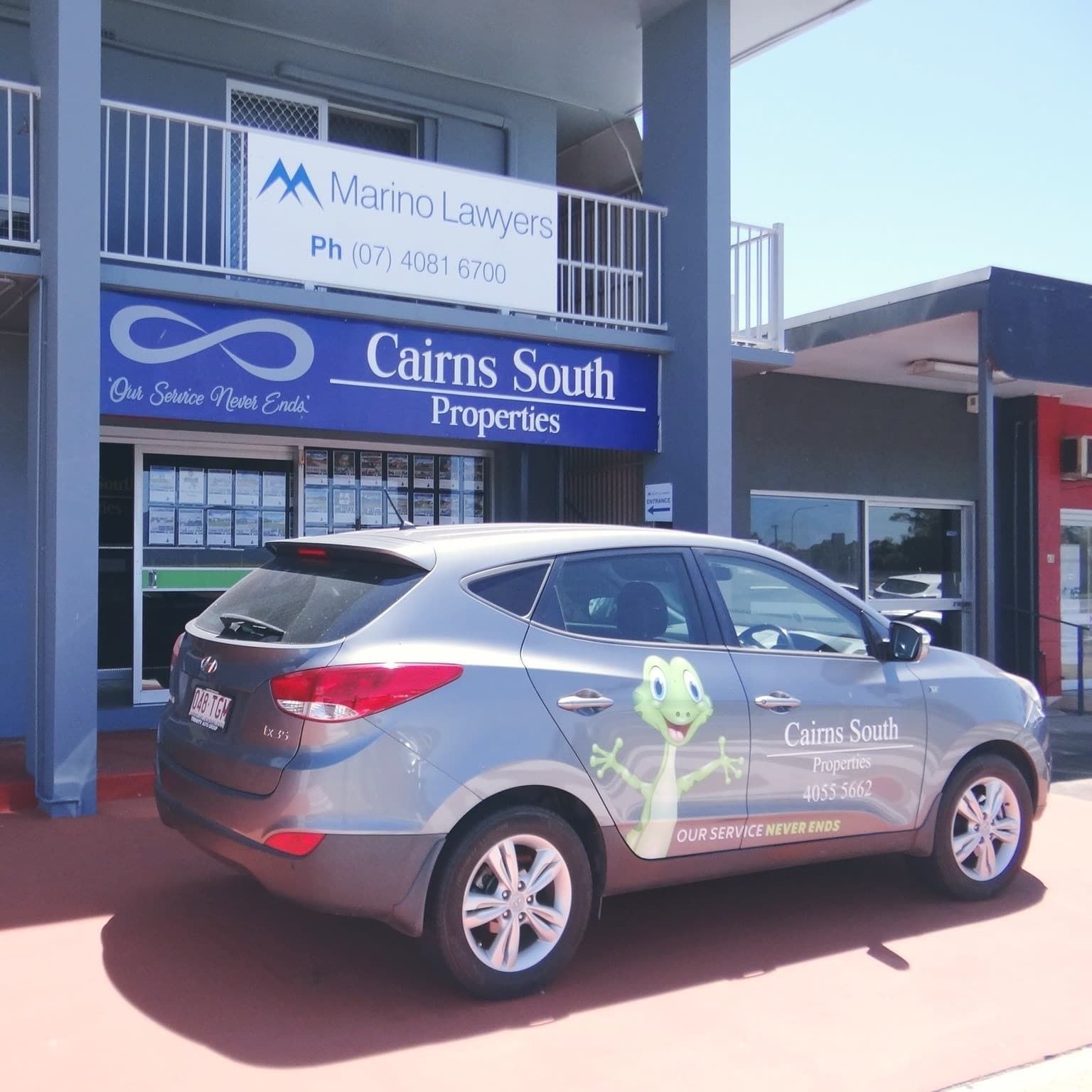 A Car Is Parked In Front Of A Building That Says Cairns South Properties — Cairns South Properties In Edmonton, QLD