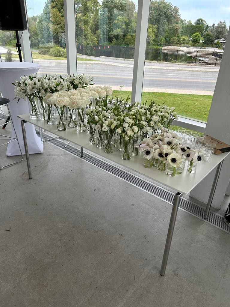 Il y a beaucoup de vases de fleurs sur la table.