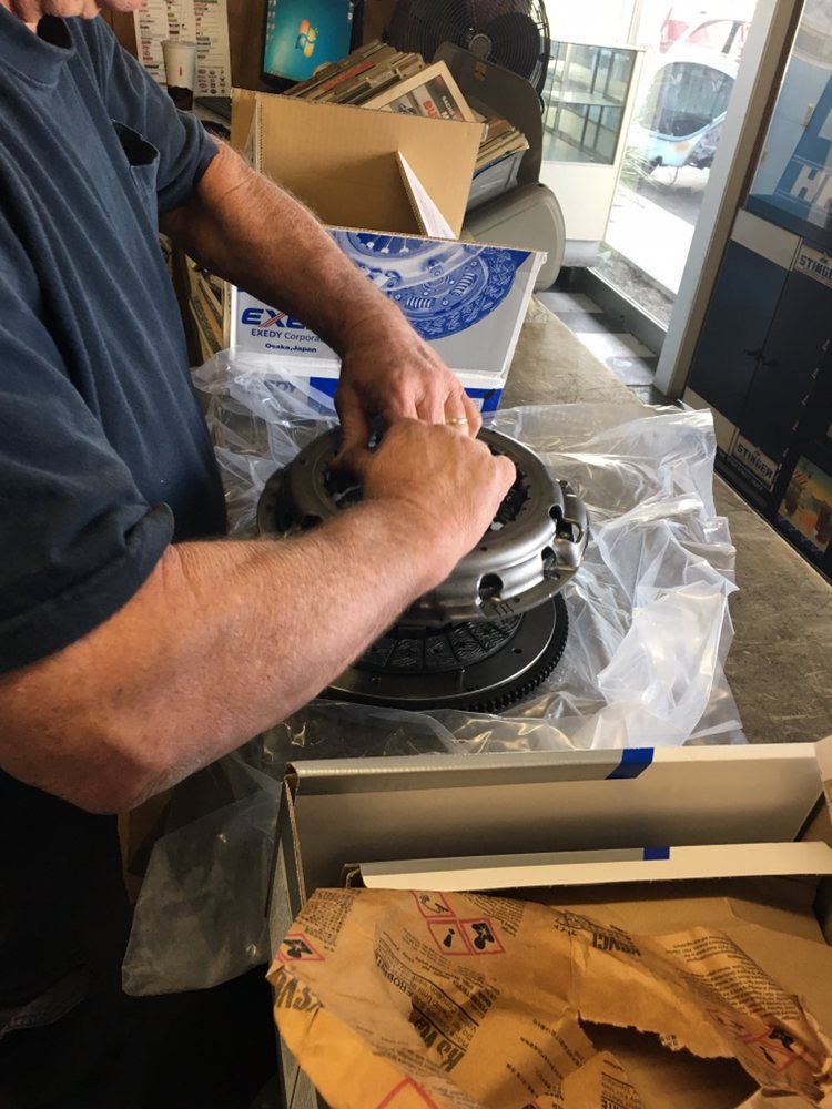 A man is working on a brake disc in a store.