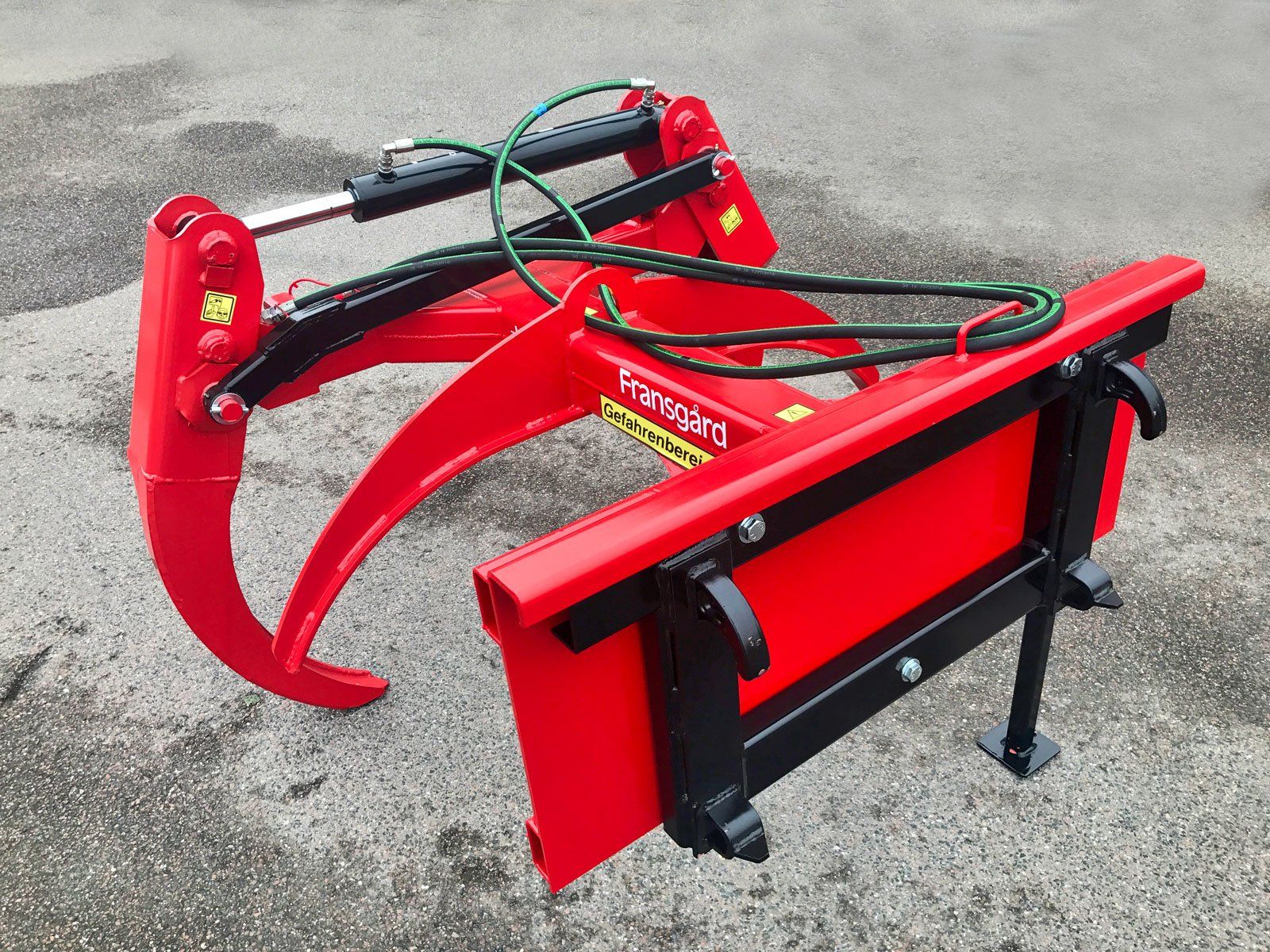 En rød skovtang med SMS-ophæng står på jorden