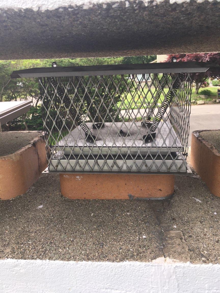 A chimney is sitting on top of a brick wall.