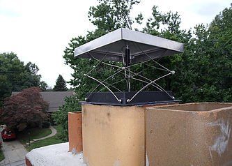 A chimney with a metal cap on top of it.