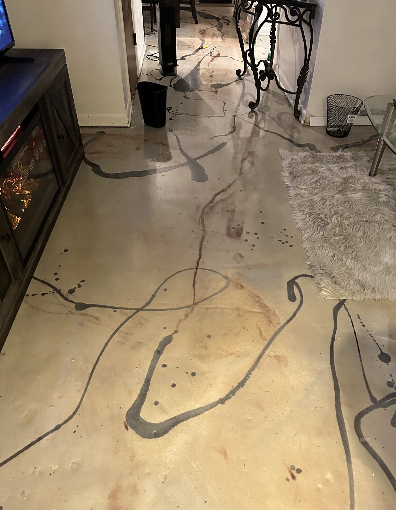 A living room with a concrete floor and a fireplace