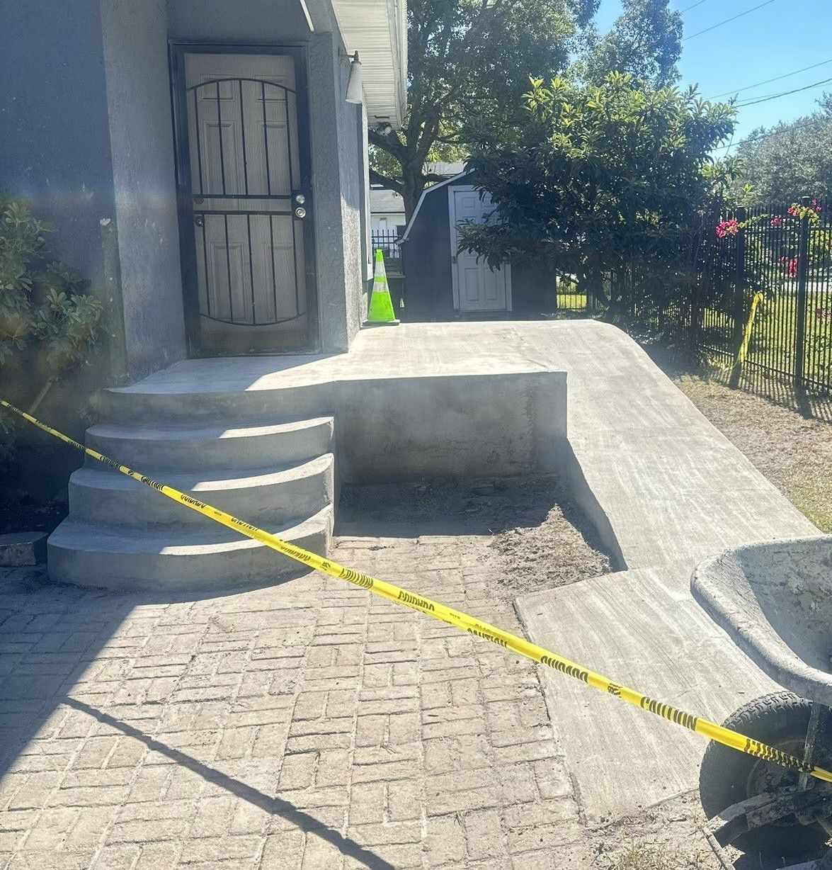 A brick walkway with a yellow caution tape around it