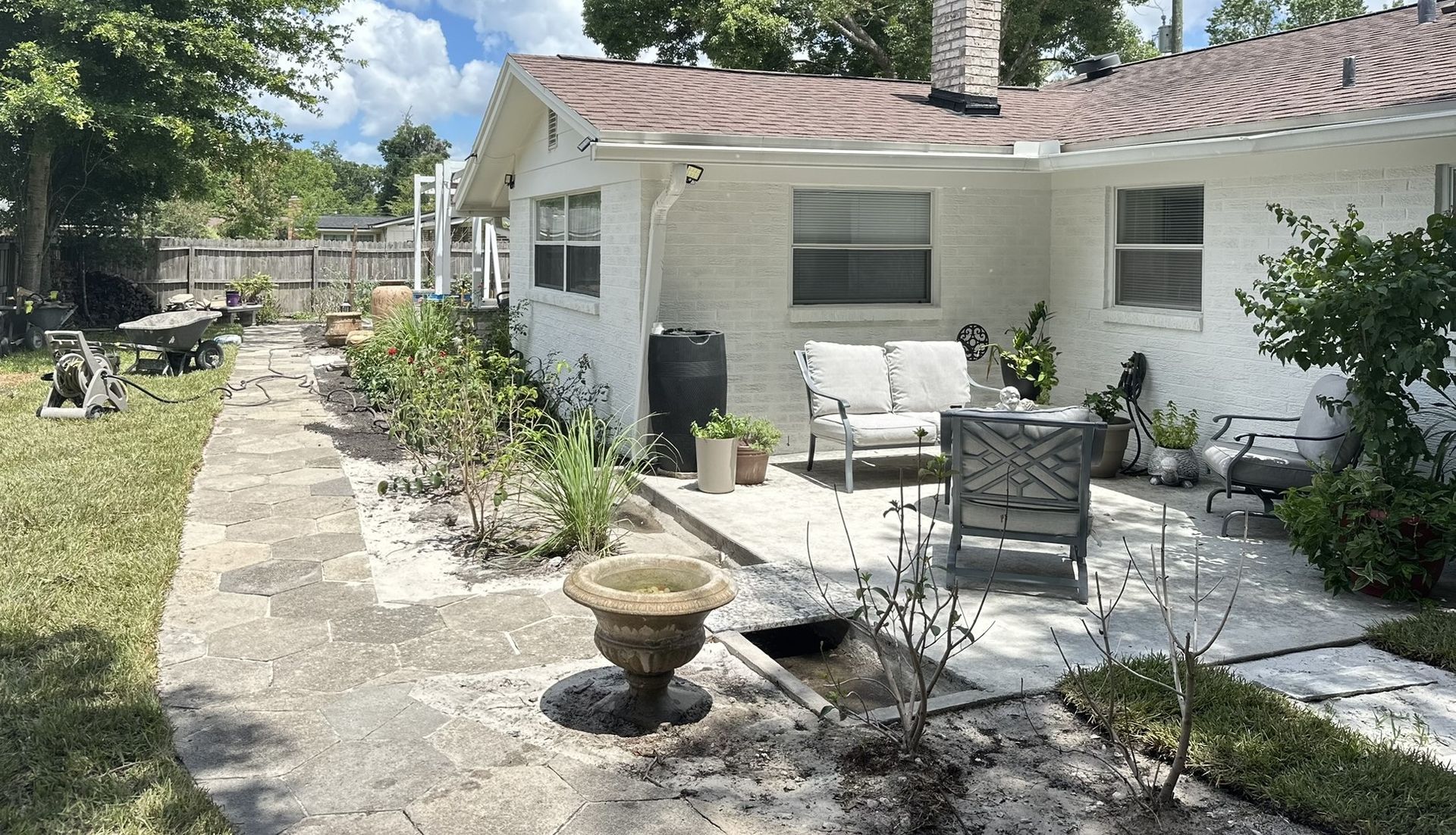 A group of construction workers are working on a concrete sidewalk.