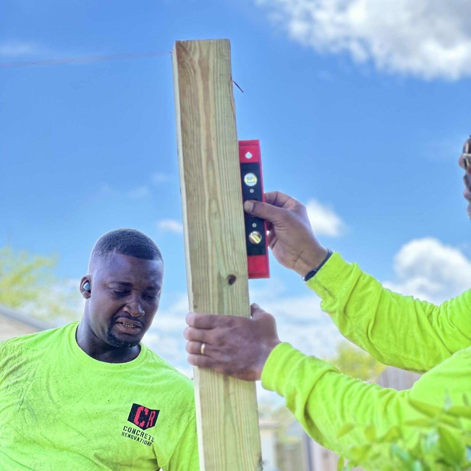 There are two chairs and a couch on the patio with a vinyl fence.