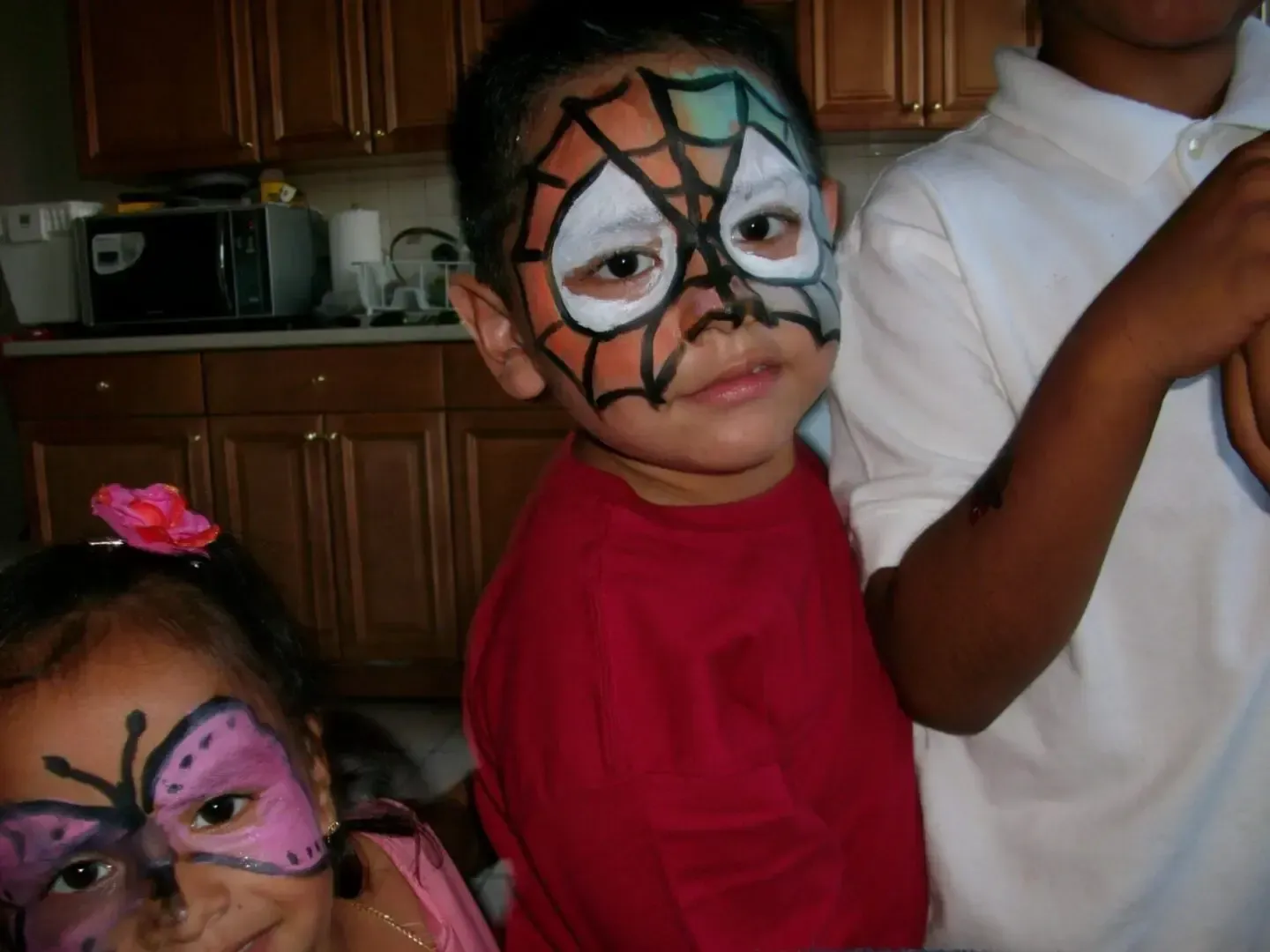 spiderman face paint on boy