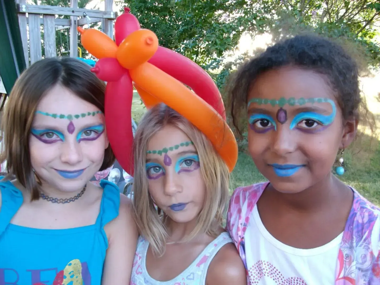 girls with face-paint and balloon hat