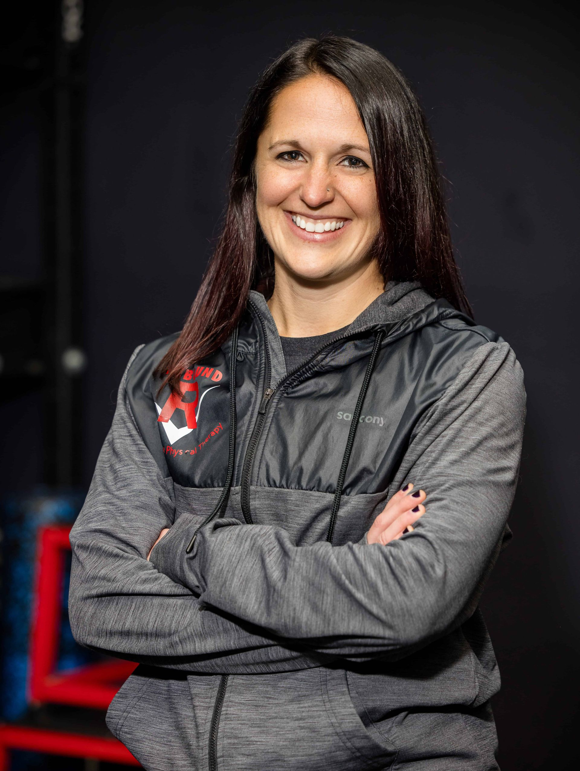 A woman wearing a black shirt with the letter r on it