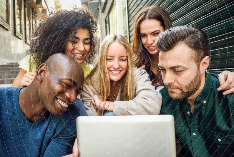 A group of people are looking at a laptop computer.