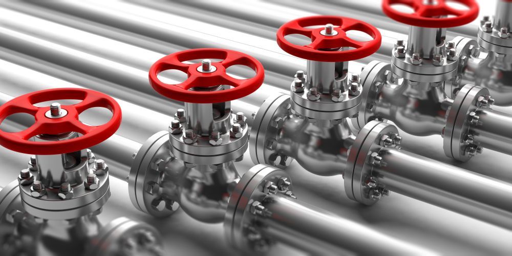 A Row Of Metal Pipes With Red Valves On Them — Warrnambool Emergency Plumbing in Warrnambool, VIC