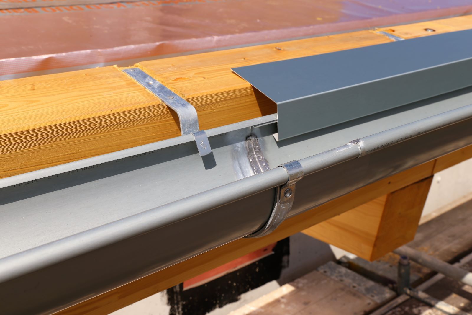 A Gutter is Being Installed on a Wooden Roof — Warrnambool Emergency Plumbing in Warrnambool, VIC