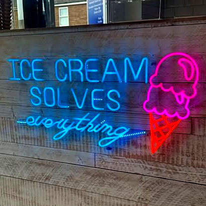 Close-up of golden pastries with white icing and almond slices.