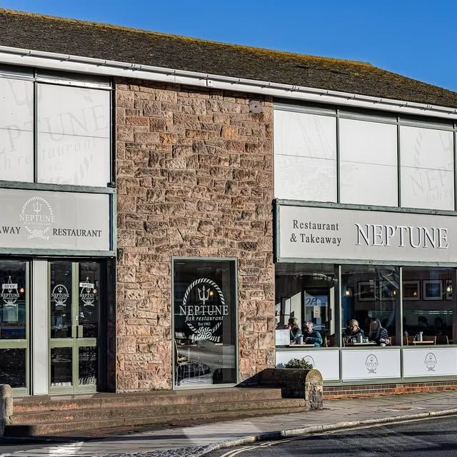 A restaurant called neptune is located in a brick building