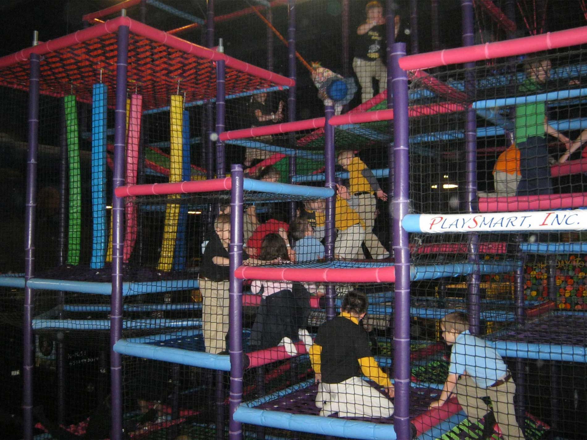 A group of people are playing in a playground with a sign that says playground