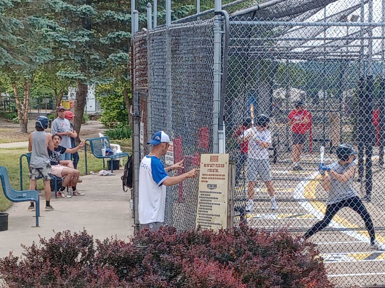 A group of people are playing baseball in a park.