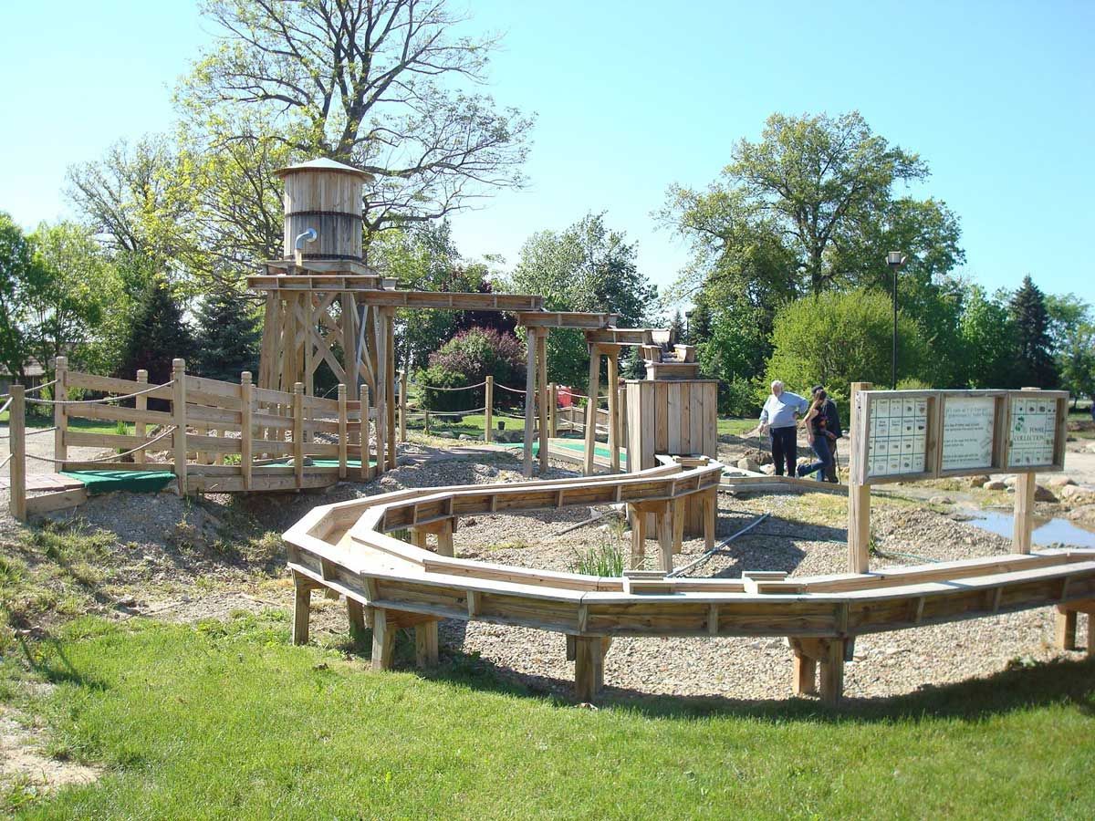 A wooden playground with a water tower in the background