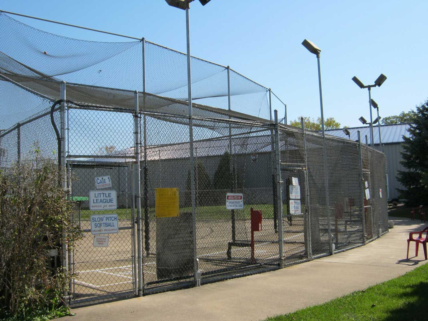 A baseball field with a fence and a sign that says no dogs