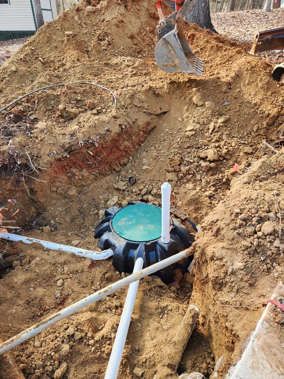 A septic tank is being installed in a hole in the ground.