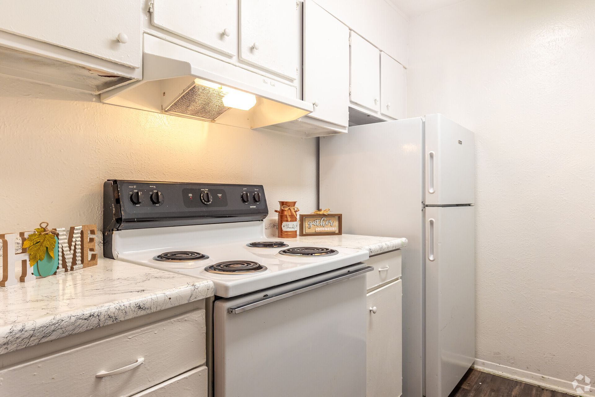A kitchen with a stove , refrigerator and dishwasher.